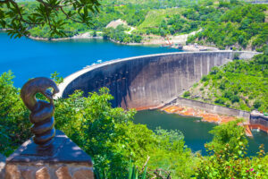 Lake Kariba dam wall and a statue of nyami nyami the river snake god.  Zambezi river.  Zimbabwe Africa.